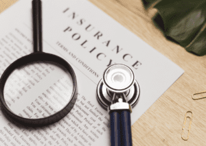 A policy document with a magnifying glass and stethoscope, symbolizing review and health of the assurance coverage.