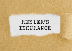 "Renter Insurance" text behind torn paper, symbolizes the importance and protection offered by renter's insurance policies.
