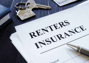 Renter Insurance document on a desk with a pen, house keychain, and money in the background, symbolizes tenant protection.