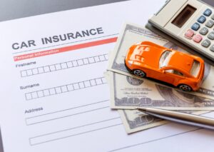 Car Insurance Company: Application form with car, bills, pen, and calculator, highlighting vehicle coverage essentials.