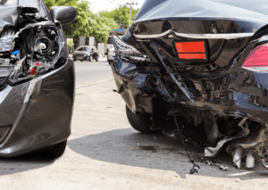 Two cars were damaged severely after a collision, emphasizing the need for auto insurance coverage.