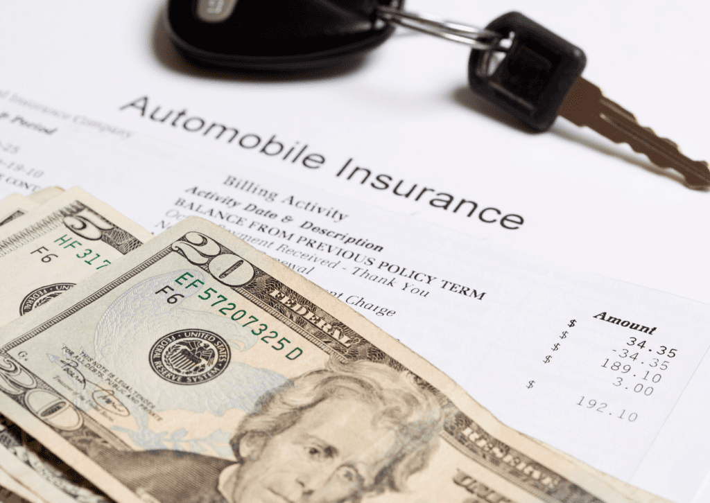 Auto insurance policy with cash and car keys, representing auto insurance in Fort Collins and the cost of coverage.