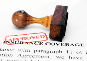 Approved insurance coverage stamp on policy document for small business insurance coverage.